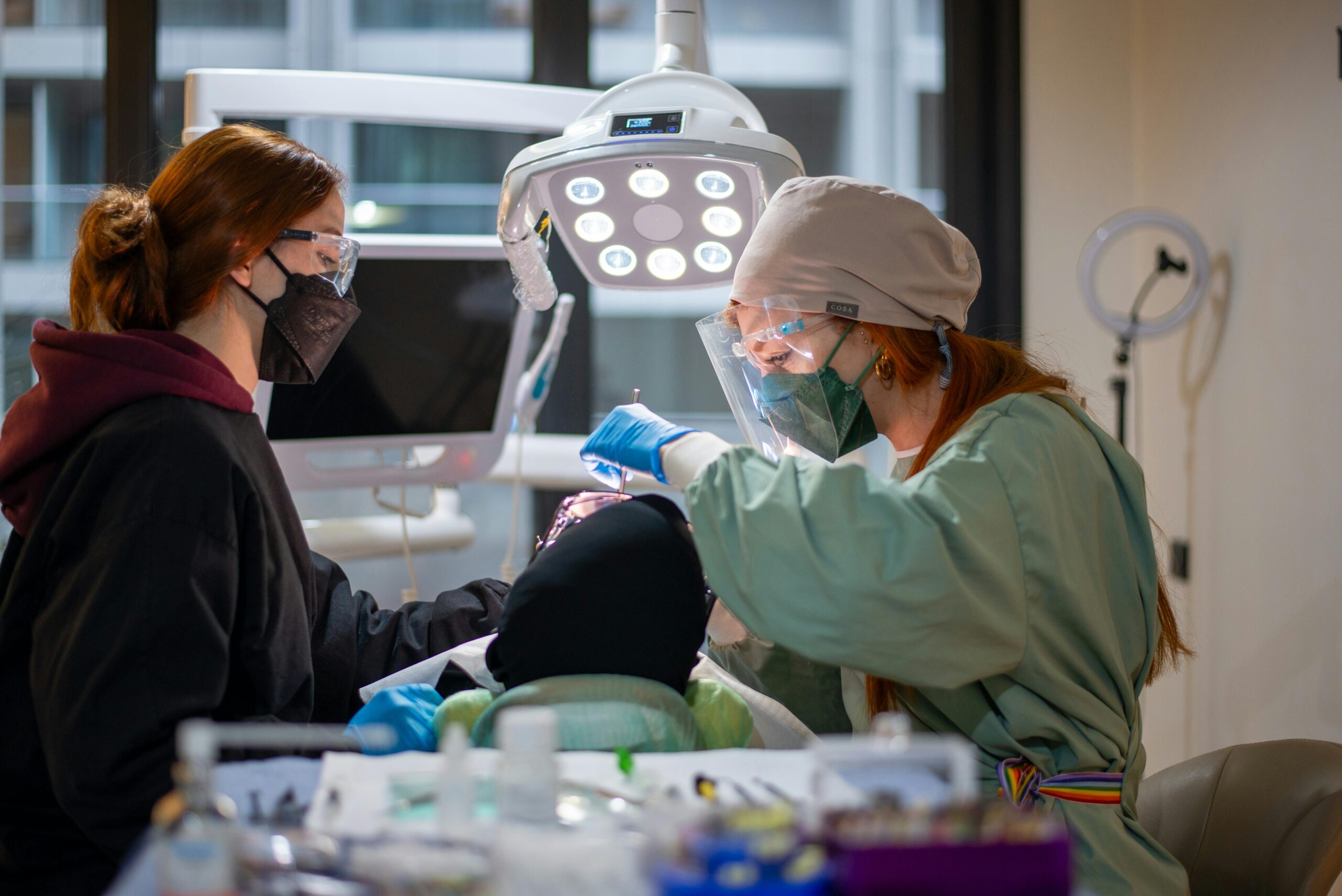 Dental team performing an advanced implant procedure in a modern dental treatment room