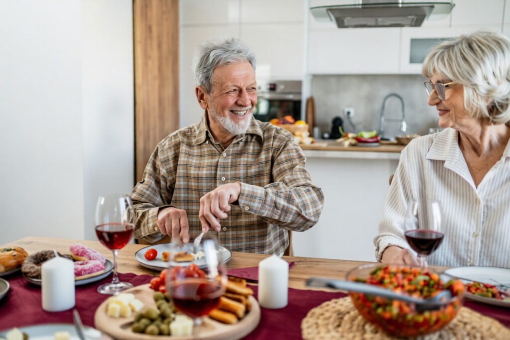 Older couple enjoying dinner comfortably after All-on-4 dental implant recovery, showing restored function and confidence.
